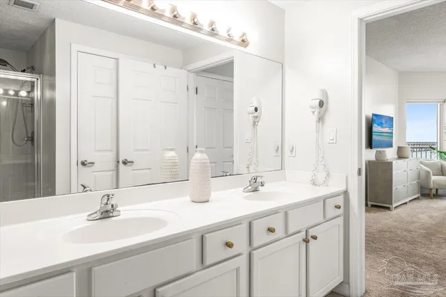 a living room with bed and a flat screen tv