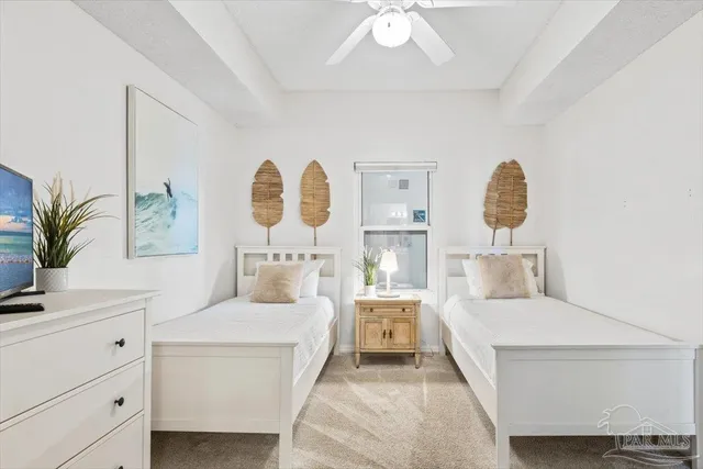 a view of bedroom with furniture and flat screen tv