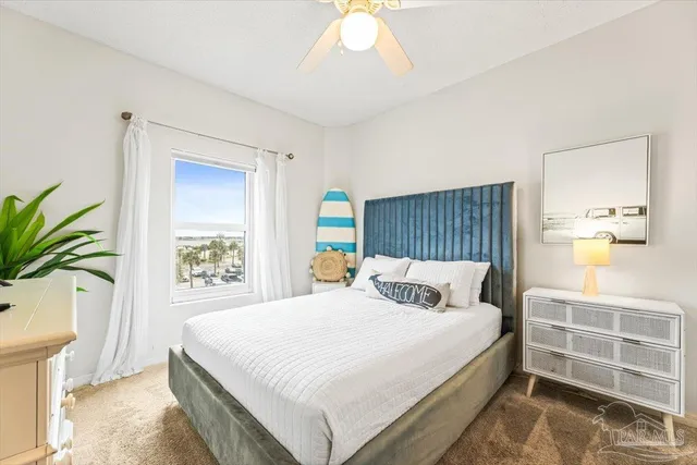 a spacious bedroom with a bed and a potted plant