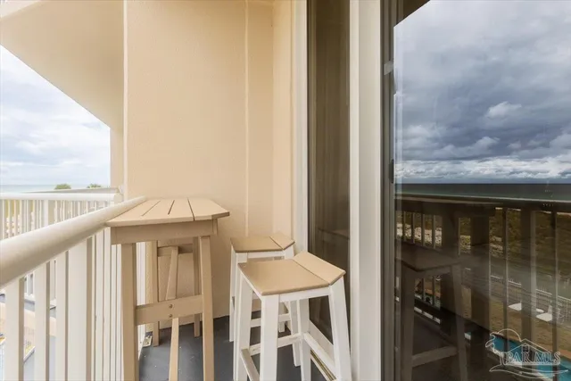 a view of a balcony with wooden floor and fence