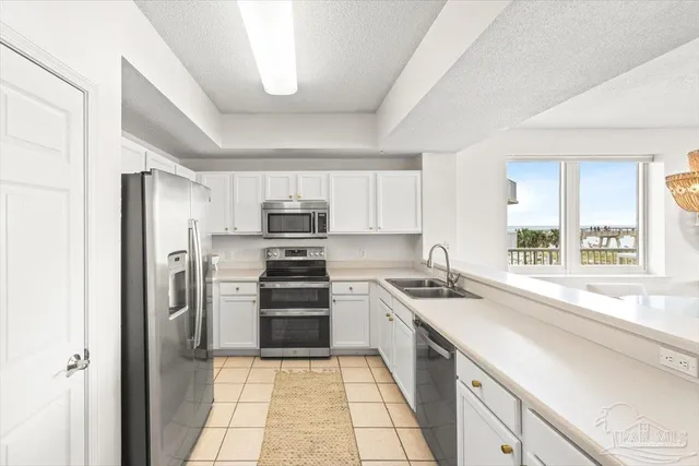 a kitchen with stainless steel appliances granite countertop a refrigerator sink and stove
