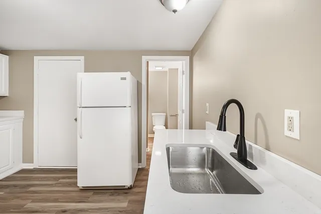 a kitchen with a refrigerator and a sink