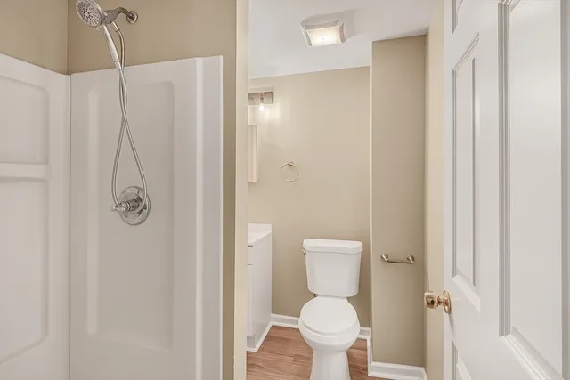 a bathroom with a toilet and a shower