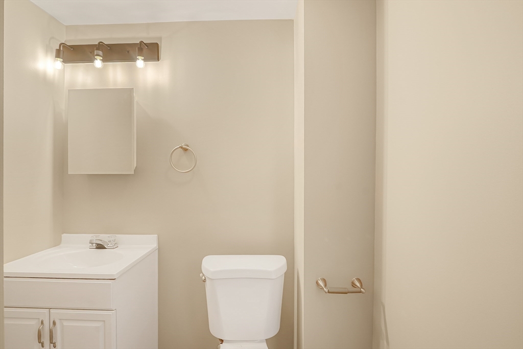 12 Franklin Avenue, Unit 2 Westfield, MA 01085 - Photo 12 of 15 a bathroom with a toilet a sink and mirror