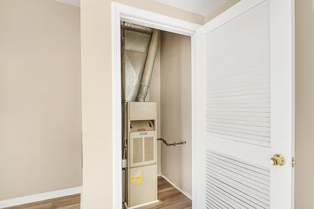 a view of closet with wooden floor
