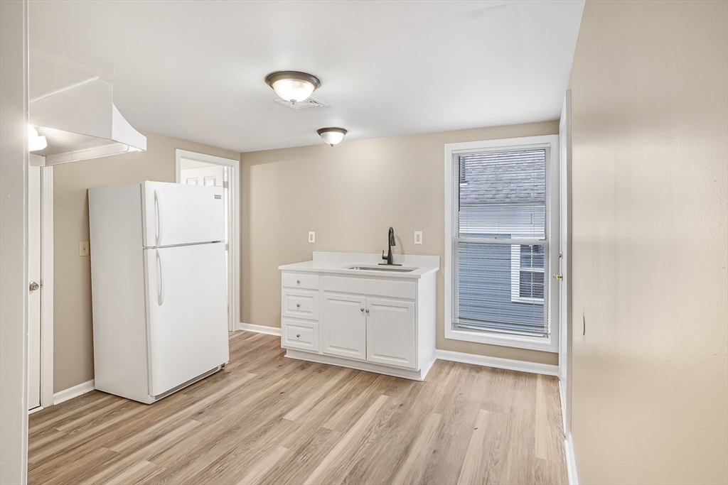 12 Franklin Avenue, Unit 2 Westfield, MA 01085 - Photo 2 of 15 a room with a refrigerator and a sink