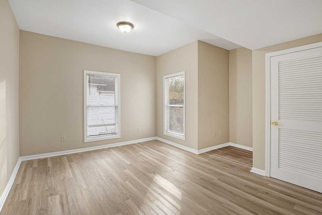 12 Franklin Avenue, Unit 2 Westfield, MA 01085 - Photo 5 of 15 an empty room with wooden floor and windows
