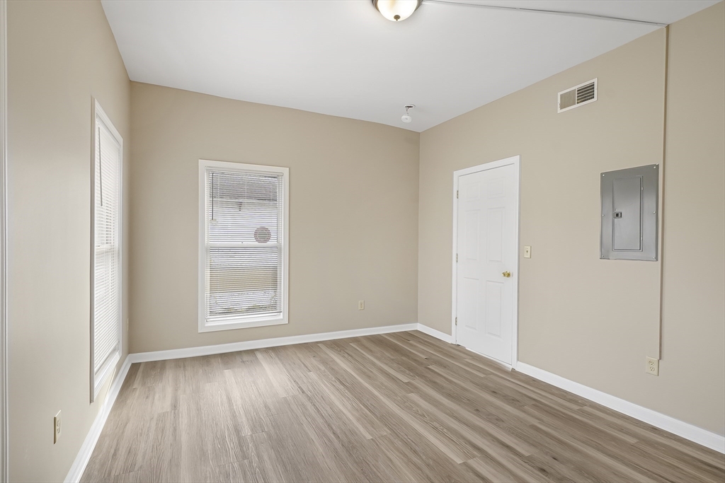 12 Franklin Avenue, Unit 2 Westfield, MA 01085 - Photo 6 of 15 an empty room with wooden floor and windows