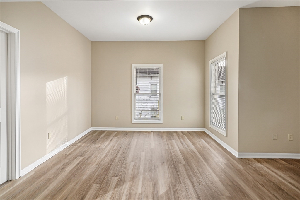 12 Franklin Avenue, Unit 2 Westfield, MA 01085 - Photo 7 of 15 an empty room with wooden floor and windows