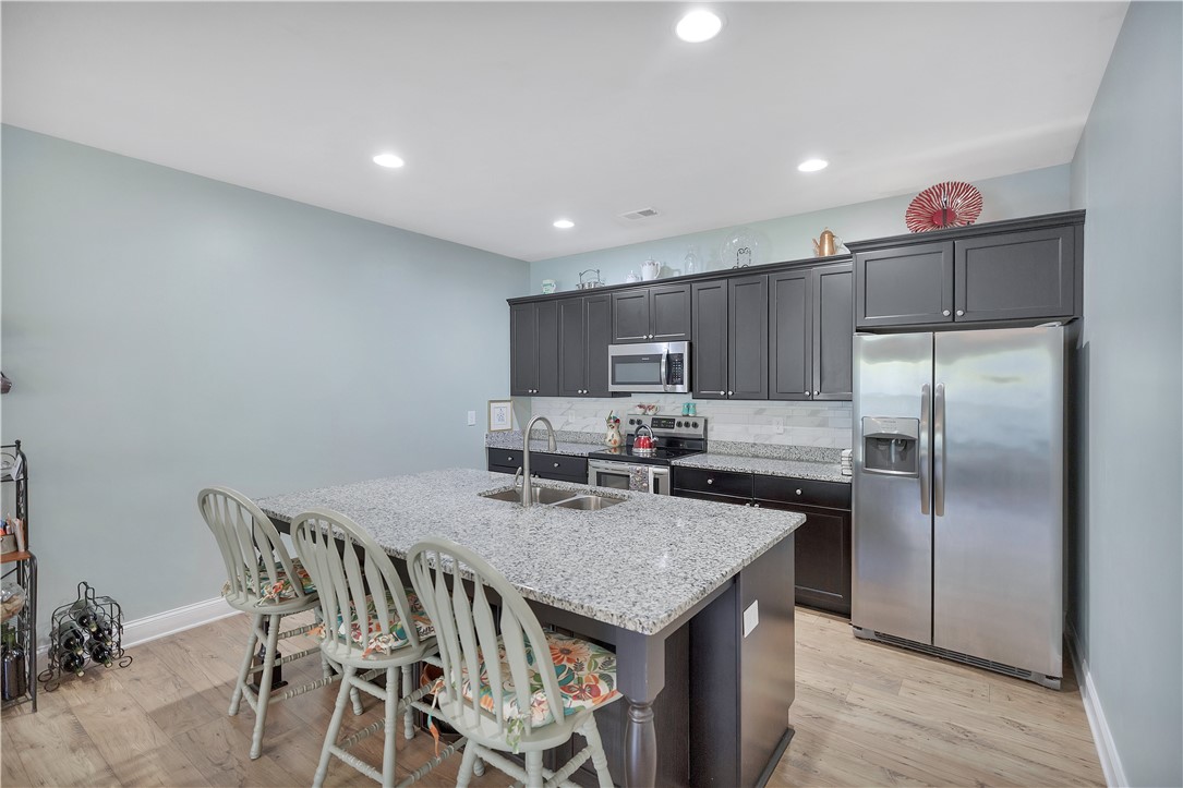 121 Ventura Street Anderson, SC 29621 - Photo 7 of 32 A well-appointed kitchen showcasing a spacious island with integrated sink and modern appliances.