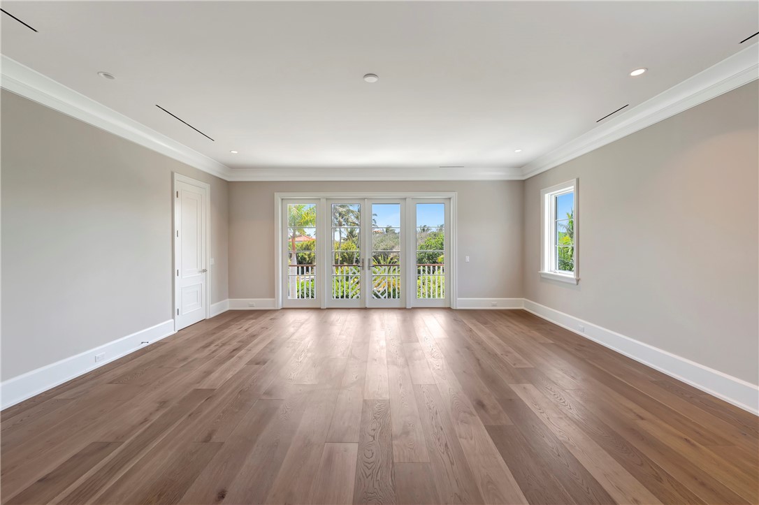 330 Blue Wave Lane Vero Beach, FL 32963 - Photo 22 of 36 an empty room with wooden floor and windows