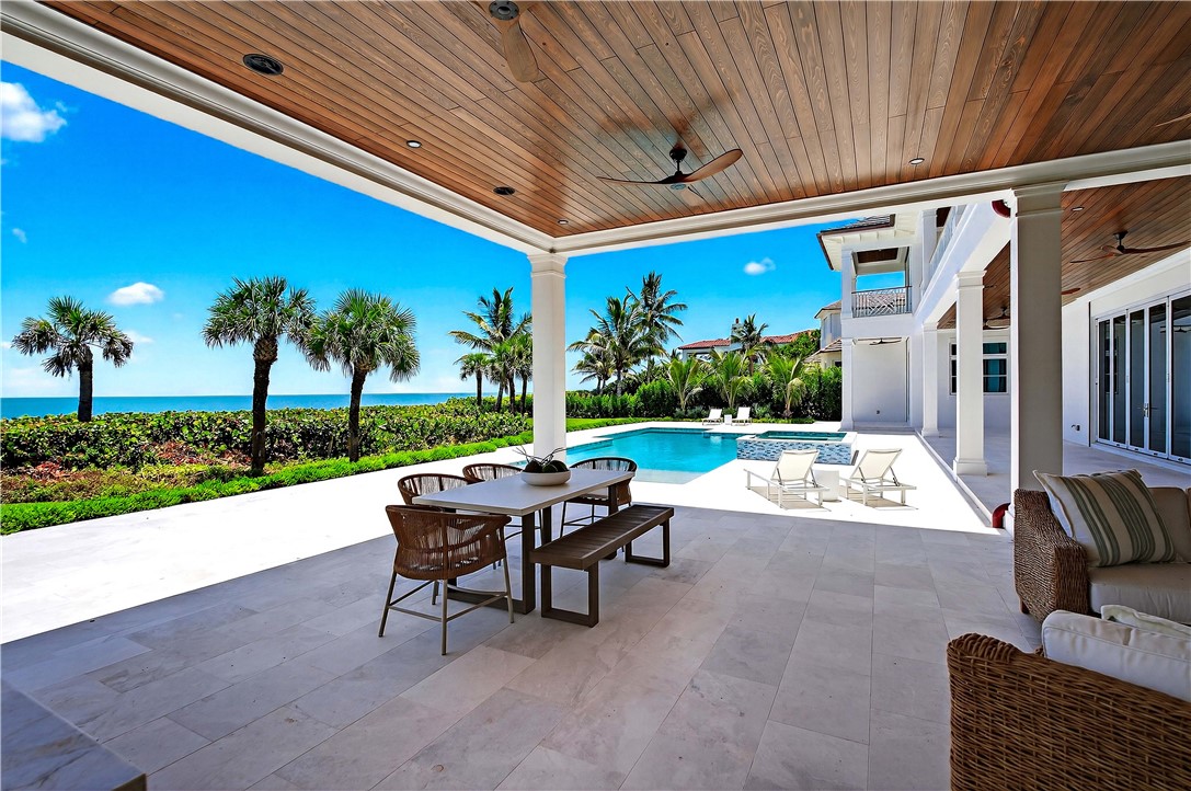 330 Blue Wave Lane Vero Beach, FL 32963 - Photo 29 of 36 a view of a patio with couches and table and chairs and potted plants