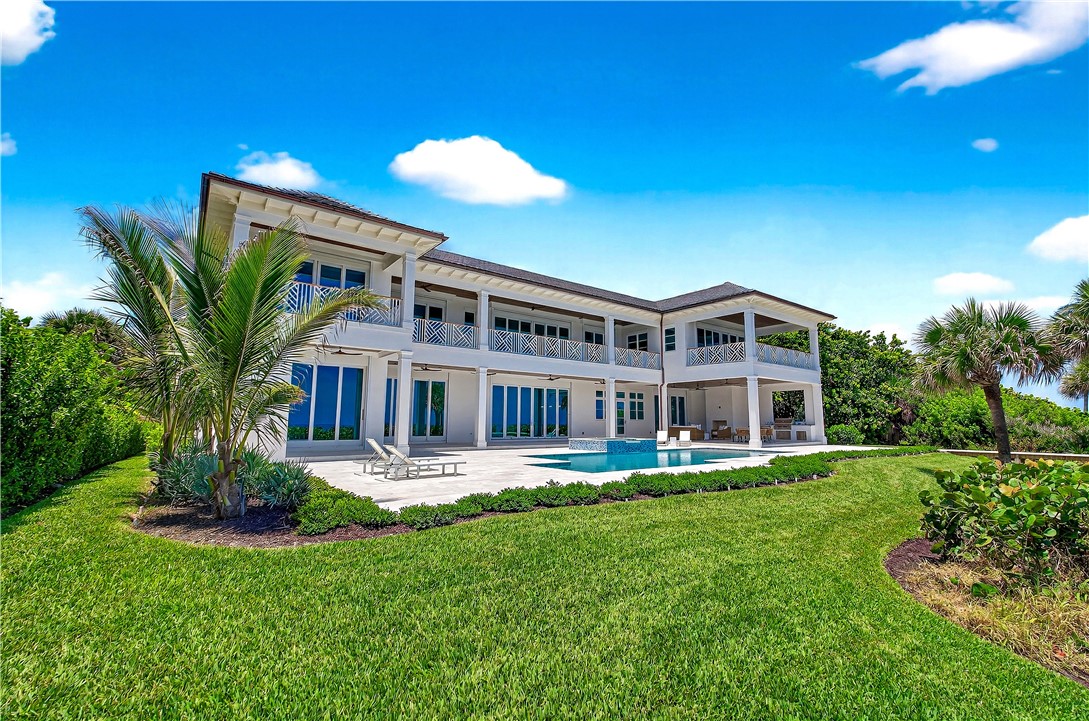 330 Blue Wave Lane Vero Beach, FL 32963 - Photo 33 of 36 a front view of a house with a yard table and chairs