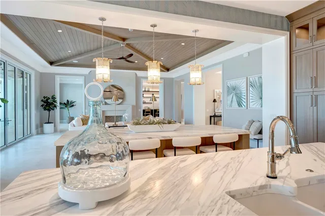 a kitchen with stainless steel appliances granite countertop a sink a stove and cabinets