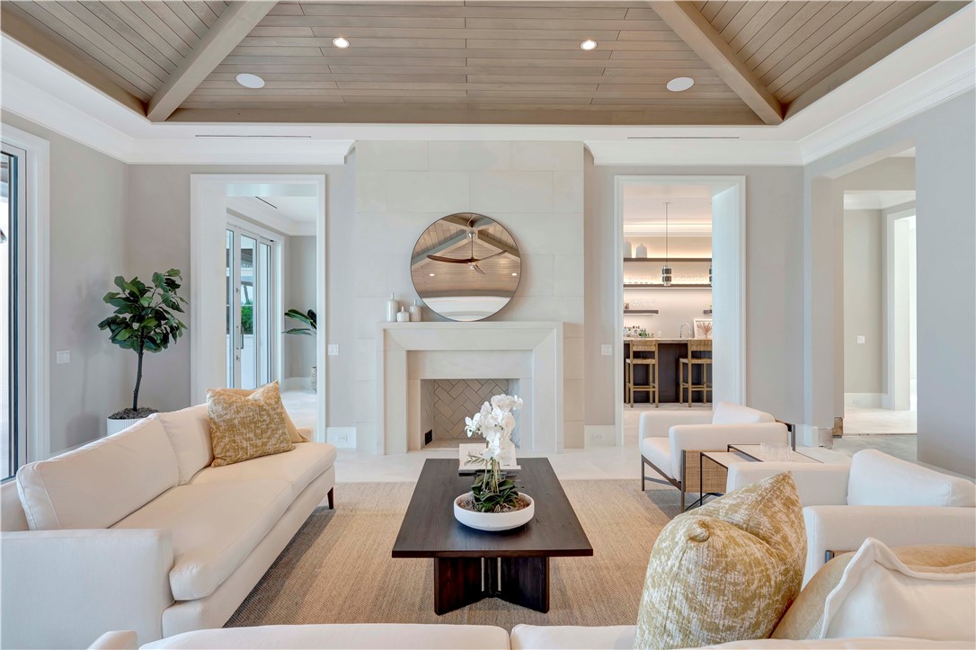 330 Blue Wave Lane Vero Beach, FL 32963 - Photo 9 of 36 a living room with furniture a fireplace and potted plants