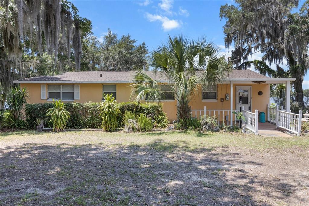 1226 South Telephone Point Road Inverness, FL 34450 - Photo 18 of 43 a front view of a house with a yard and trees