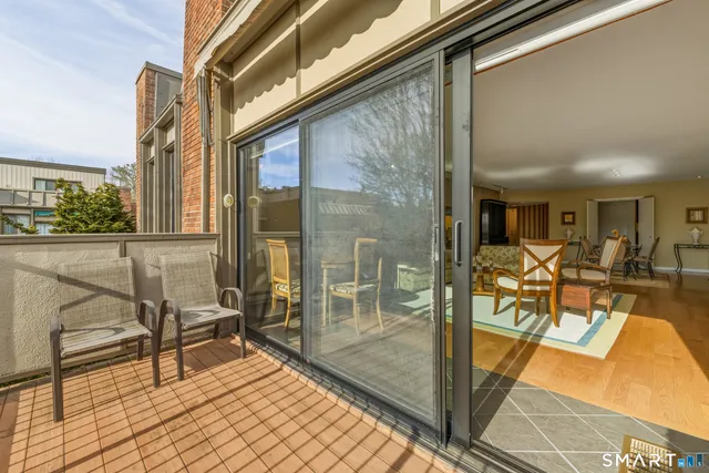 a view of a balcony with chairs