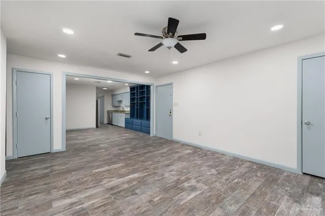 a view of kitchen with wooden floor and electronic appliances