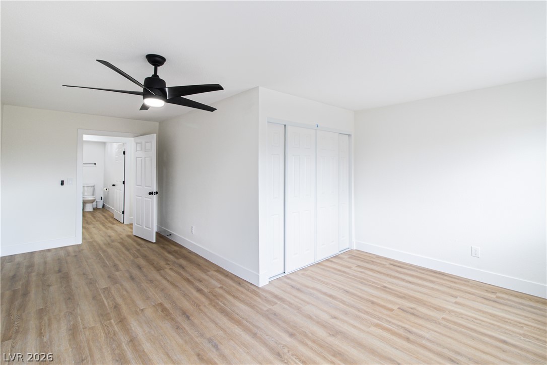 1891 Brian Road Pahrump, NV 89048 - Photo 43 of 50 Unfurnished bedroom with a closet, baseboards, light wood-style floors, and a ceiling fan