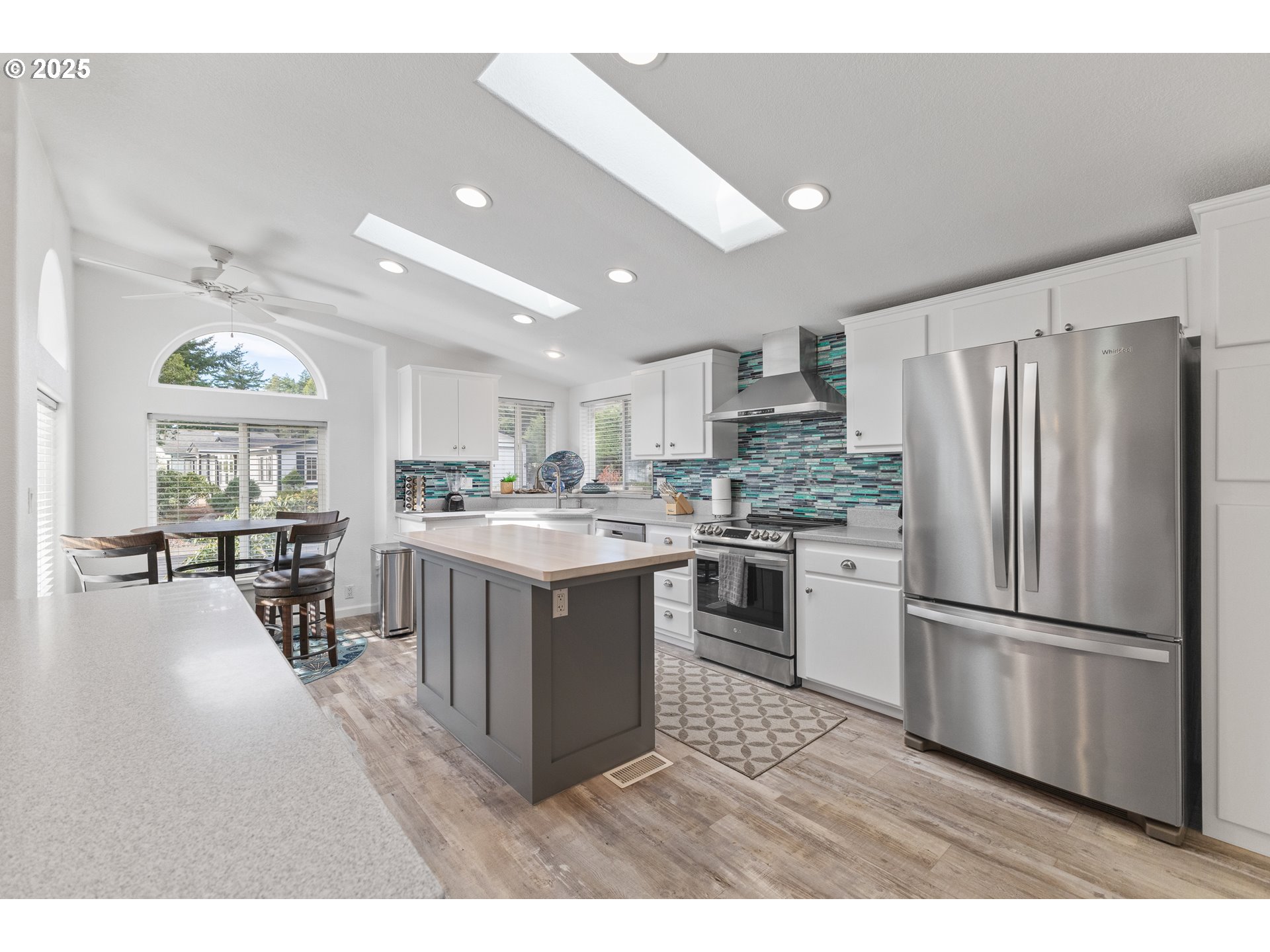 852 Munsel Creek Loop Florence, OR 97439 - Photo 14 of 48 a kitchen with stainless steel appliances granite countertop a refrigerator a sink dishwasher a stove with white cabinets