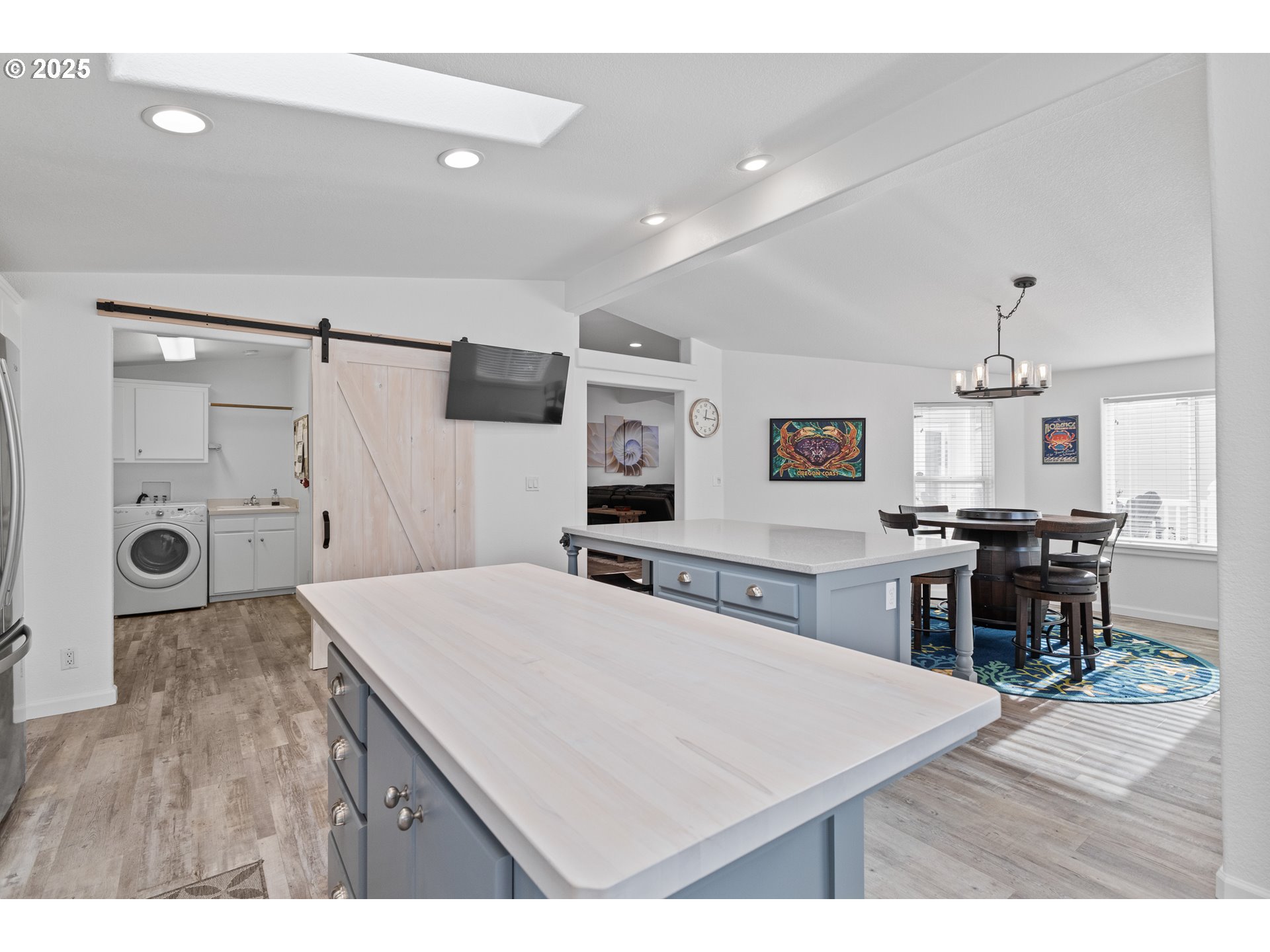 852 Munsel Creek Loop Florence, OR 97439 - Photo 18 of 48 a living room with stainless steel appliances kitchen island a table and chairs