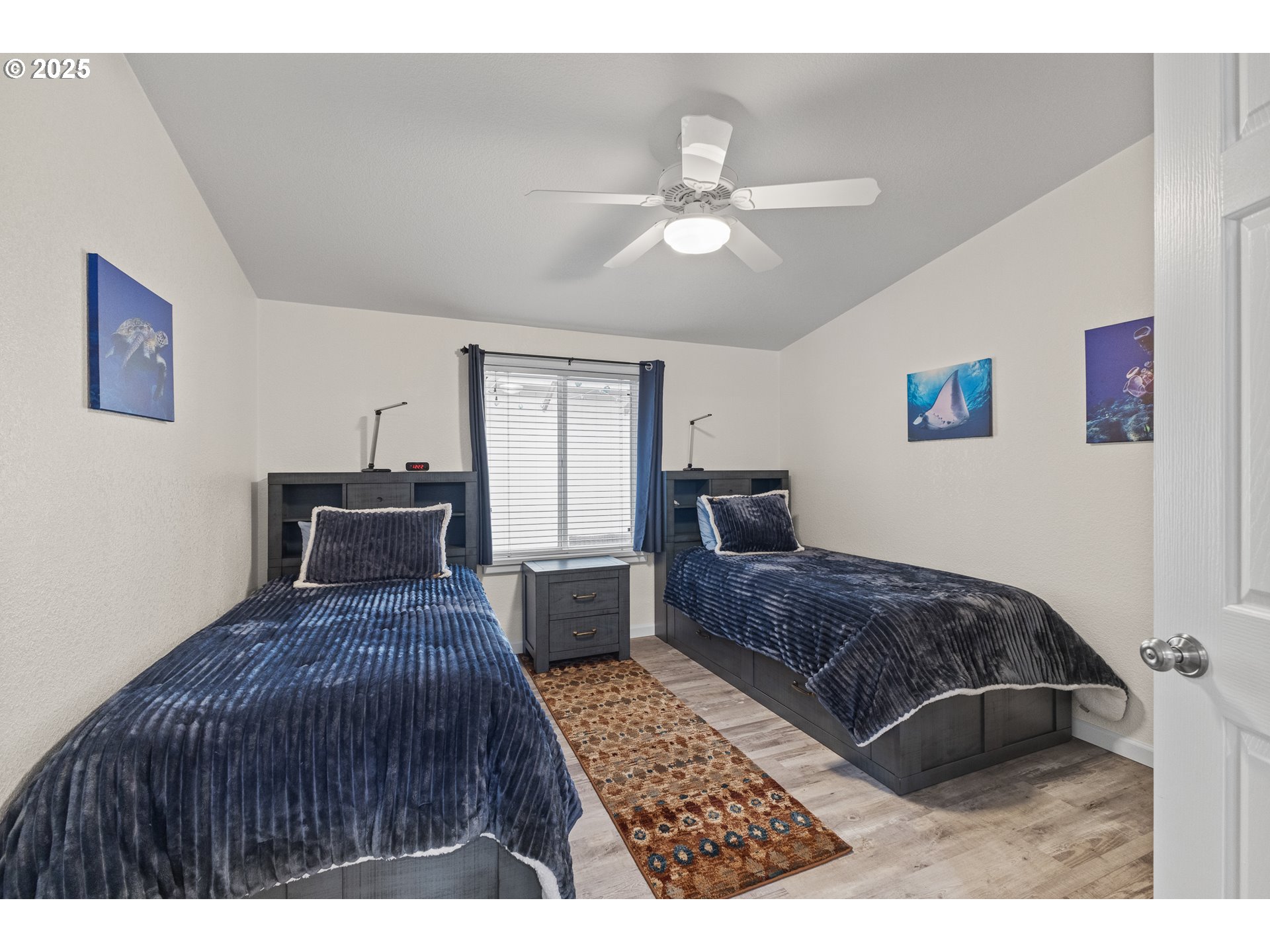 852 Munsel Creek Loop Florence, OR 97439 - Photo 28 of 48 a bedroom with a large bed and a chandelier
