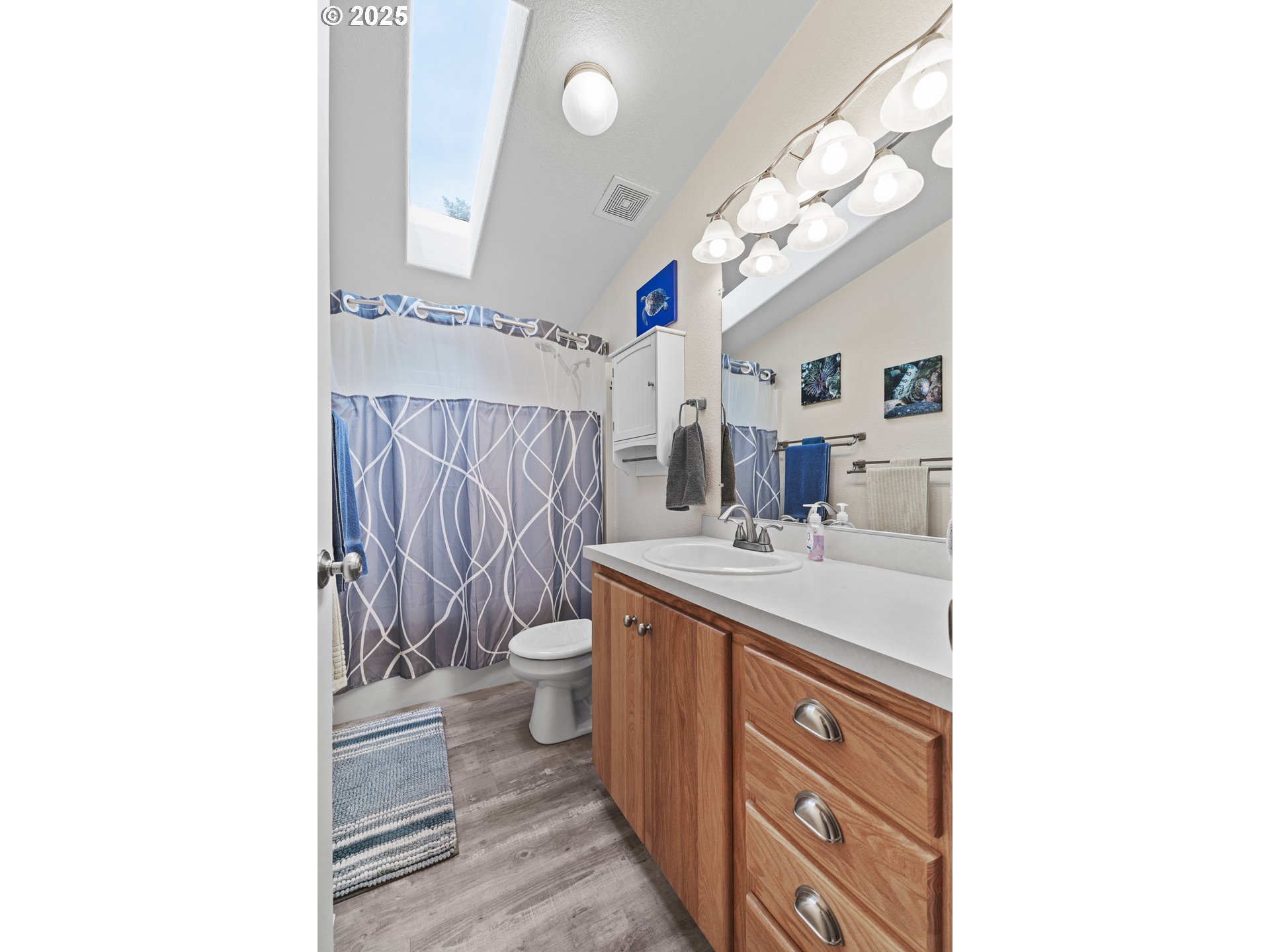 852 Munsel Creek Loop Florence, OR 97439 - Photo 38 of 48 a bathroom with a sink a toilet and a mirror