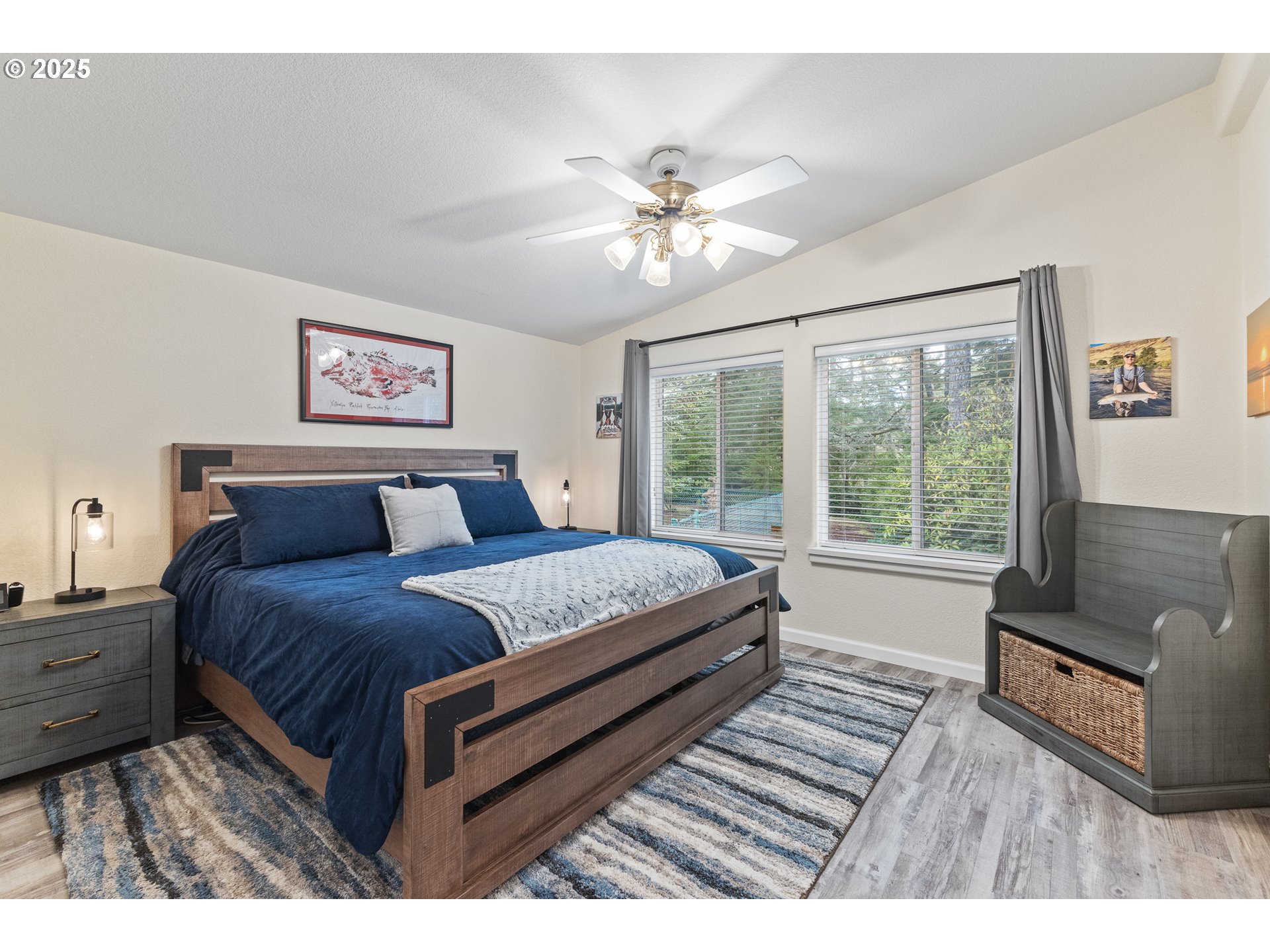 852 Munsel Creek Loop Florence, OR 97439 - Photo 39 of 48 a bedroom with a large bed a chandelier and a window