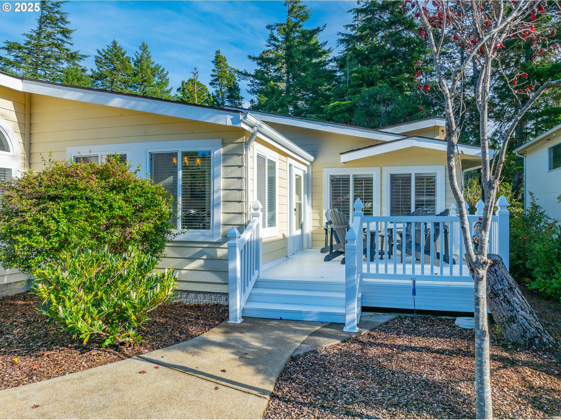852 Munsel Creek Loop Florence, OR 97439 - Photo 4 of 48 a view of a house with a yard and sitting area
