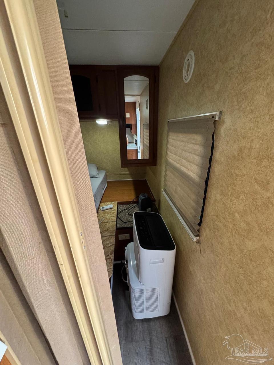 612 Rentz Avenue Pensacola, FL 32507 - Photo 13 of 18 a room with wooden floor and furniture