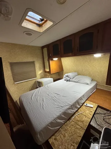 a bedroom with a bed and a lamp with the view of a room