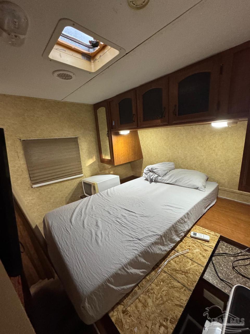 612 Rentz Avenue Pensacola, FL 32507 - Photo 14 of 18 a bedroom with a bed and a lamp with the view of a room