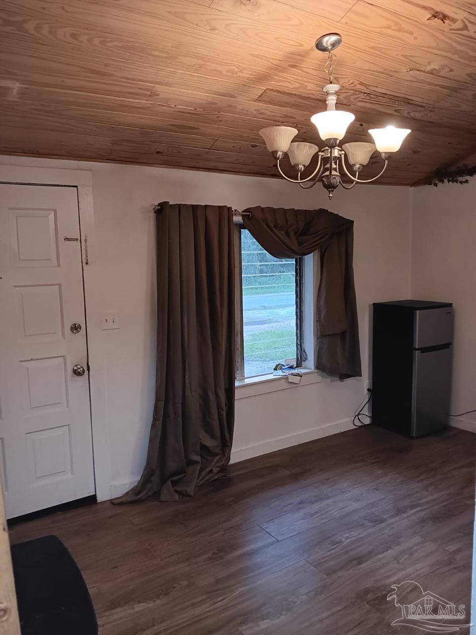 612 Rentz Avenue Pensacola, FL 32507 - Photo 3 of 18 a view of a room with wooden floor and a large window