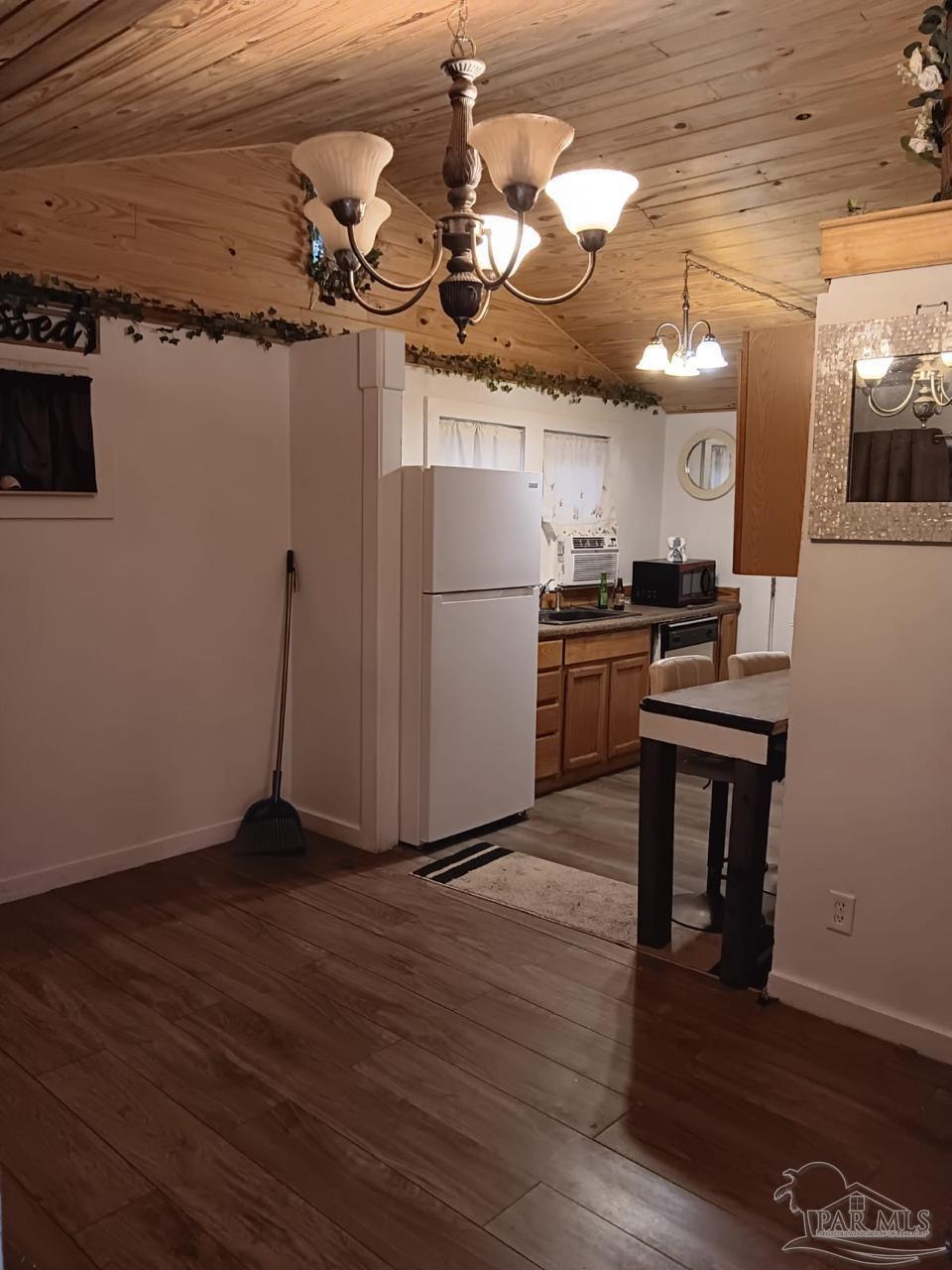 612 Rentz Avenue Pensacola, FL 32507 - Photo 5 of 18 a kitchen with a refrigerator a stove and wooden floor