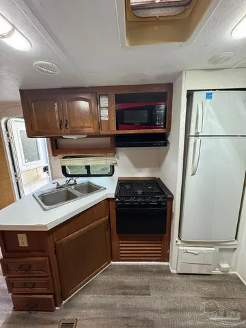 a kitchen with a stove and a refrigerator