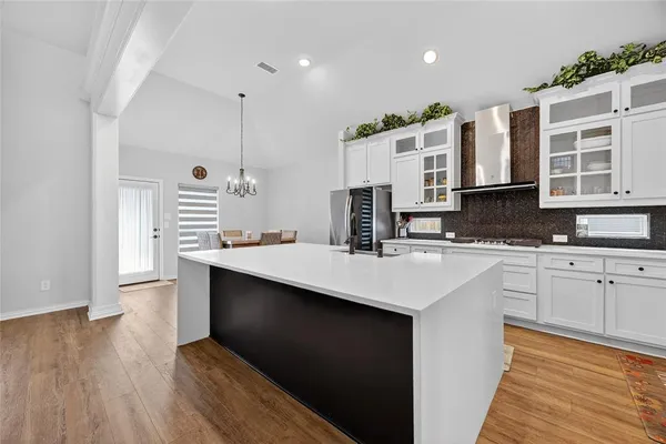 a kitchen with stainless steel appliances sink stove and cabinets