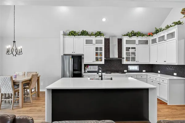 a kitchen with stainless steel appliances kitchen island granite countertop a sink and cabinets