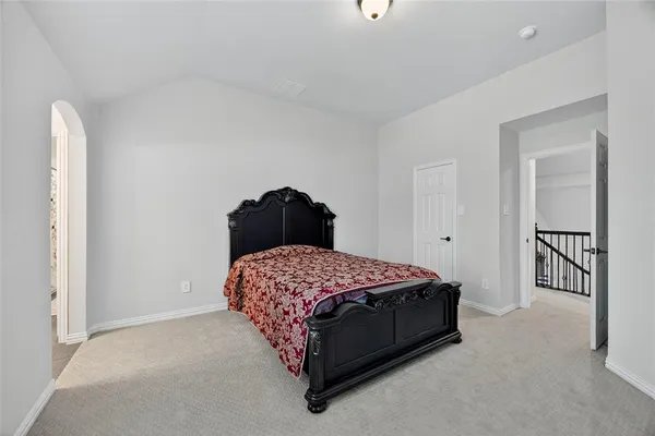 a bedroom with a bed and table