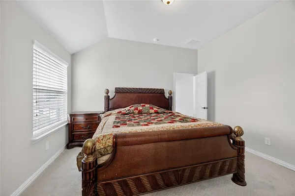 a bedroom with a bed and window