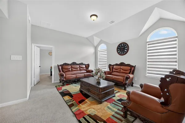 a living room with furniture a rug and a window