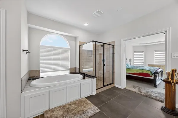 a bedroom with furniture and a window