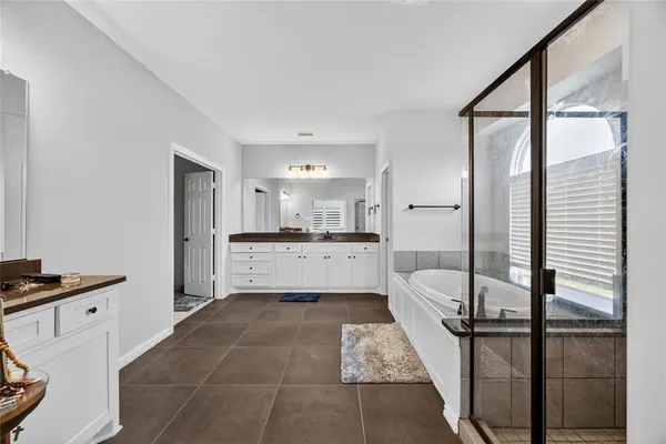 a large white kitchen with white cabinets and a stainless steel appliances