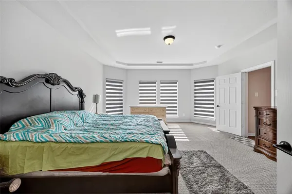 a bedroom with a bed and dresser