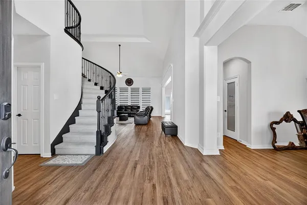 a view of a room with wooden floor and stairs