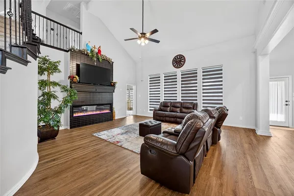 a living room with furniture a fireplace and a flat screen tv