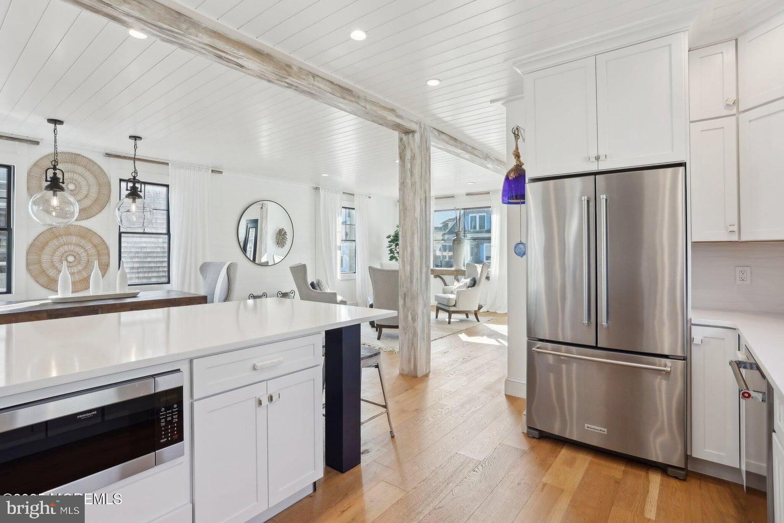 211 4th Street Beach Haven, NJ 08008 - Photo 11 of 48 a kitchen with stainless steel appliances a refrigerator sink and cabinets