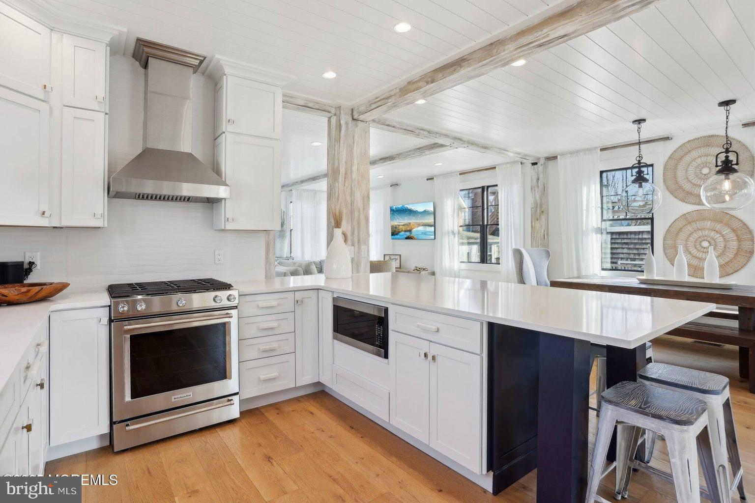 211 4th Street Beach Haven, NJ 08008 - Photo 13 of 48 a kitchen with stainless steel appliances a stove a sink and a refrigerator