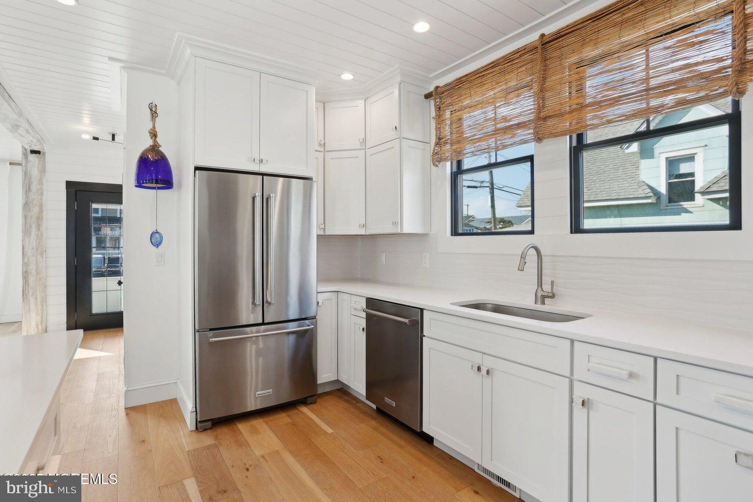 211 4th Street Beach Haven, NJ 08008 - Photo 14 of 48 a kitchen with stainless steel appliances a refrigerator sink and cabinets