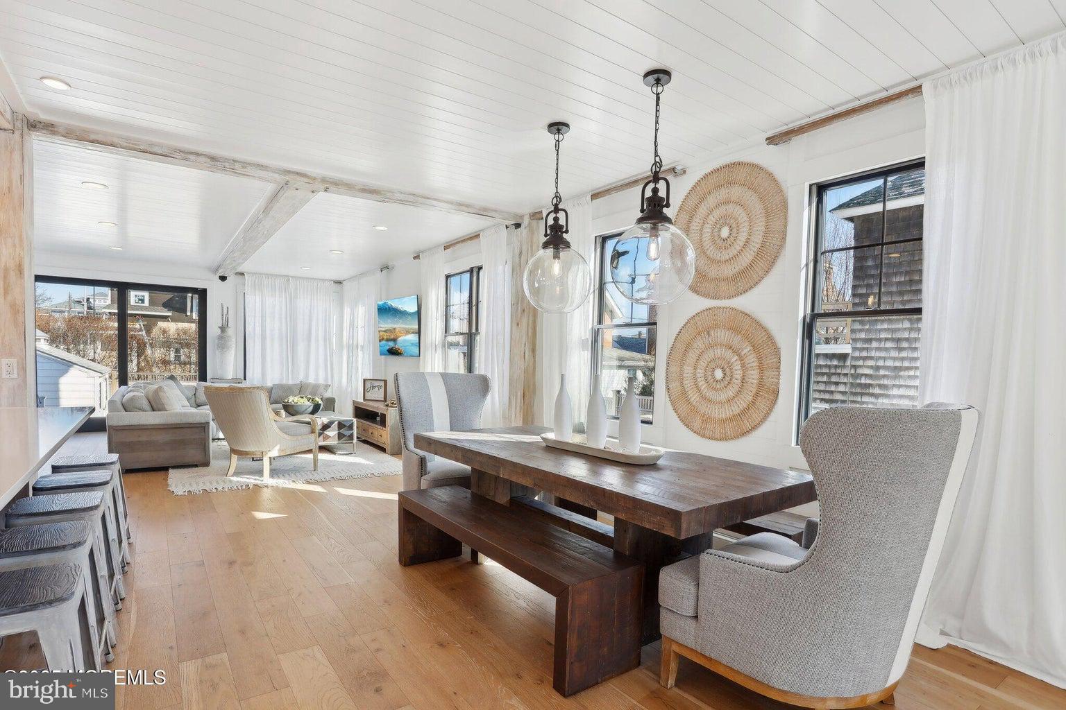 211 4th Street Beach Haven, NJ 08008 - Photo 15 of 48 a living room with couches a clock on wall and a window