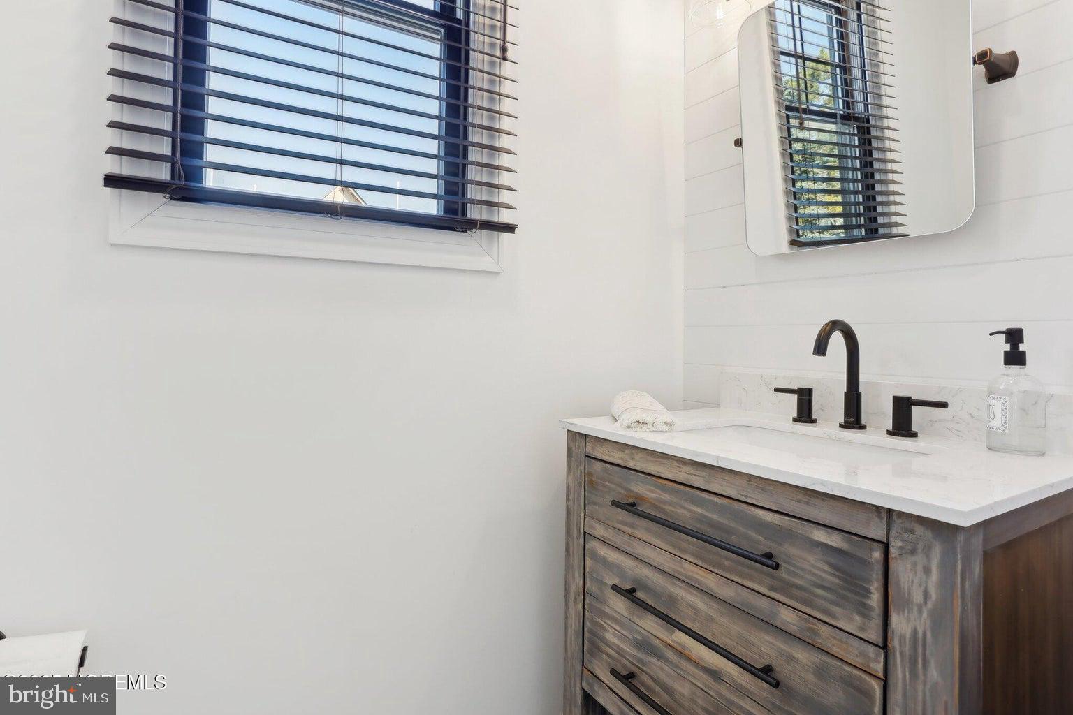 211 4th Street Beach Haven, NJ 08008 - Photo 22 of 48 a bathroom with a sink and a mirror